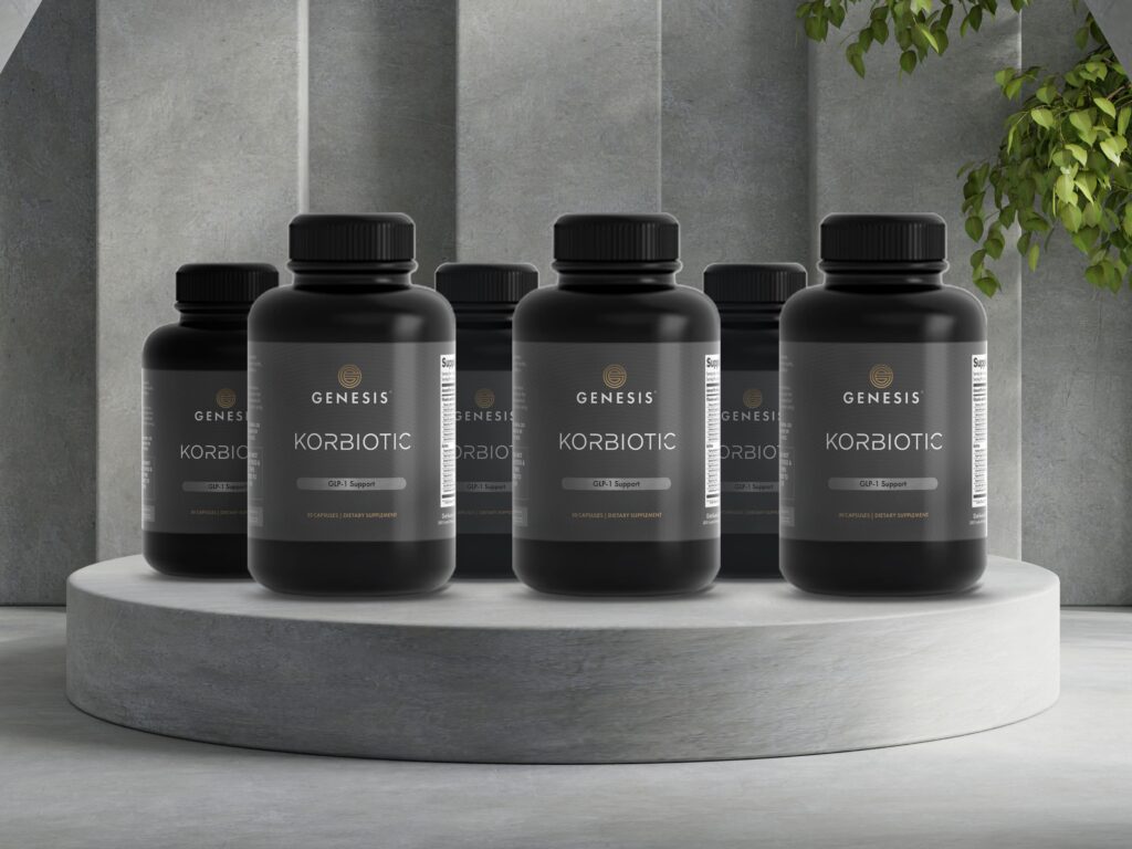 6 black bottles of Korbiotic by Genesis Supplements lined up in a white slate