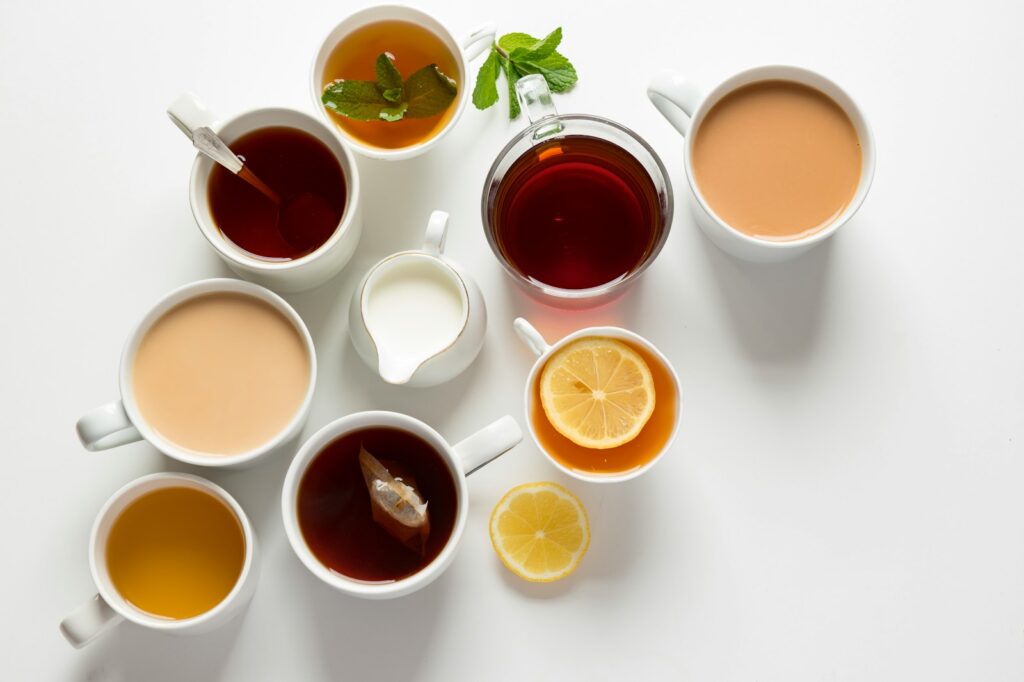 variety of caffeine free beverage filled glasses and cups such as herbal tea, coffee latte, and low fat milk