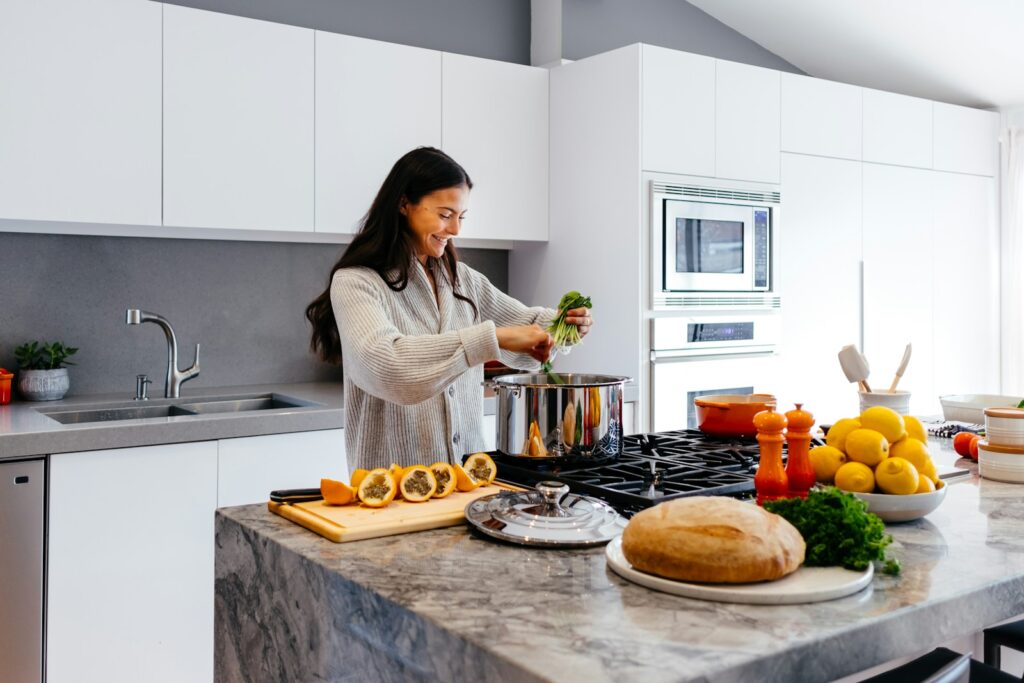 a black and long haired latin american woman preparing healthy meals and cooking soups made of fresh vegetables combining probiotics and glp-1 for weight loss