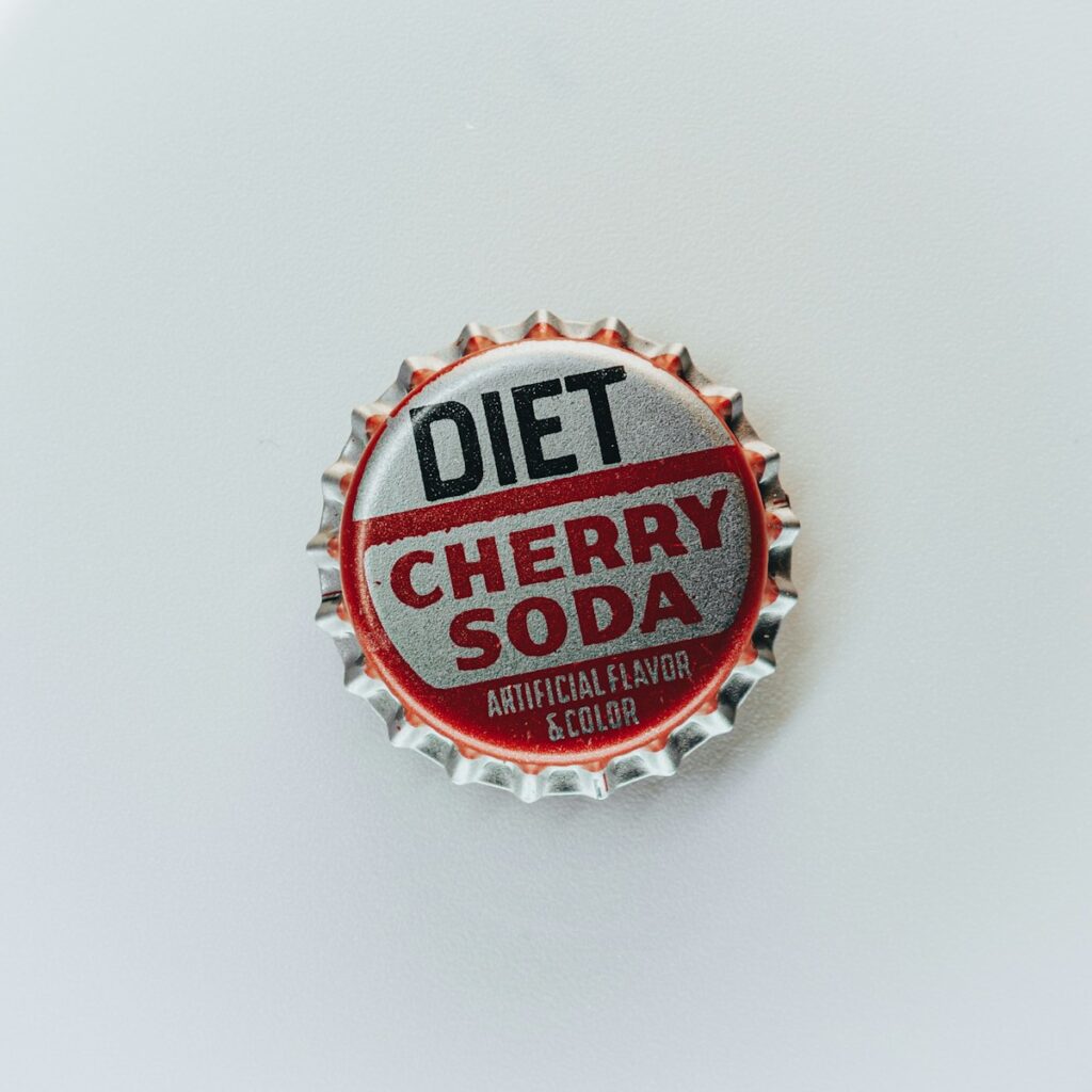 a silver tin bottle cap that says diet cherry soda