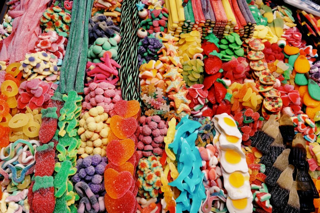 assorted-color gummy candies on display with long strips and animal shaped candy