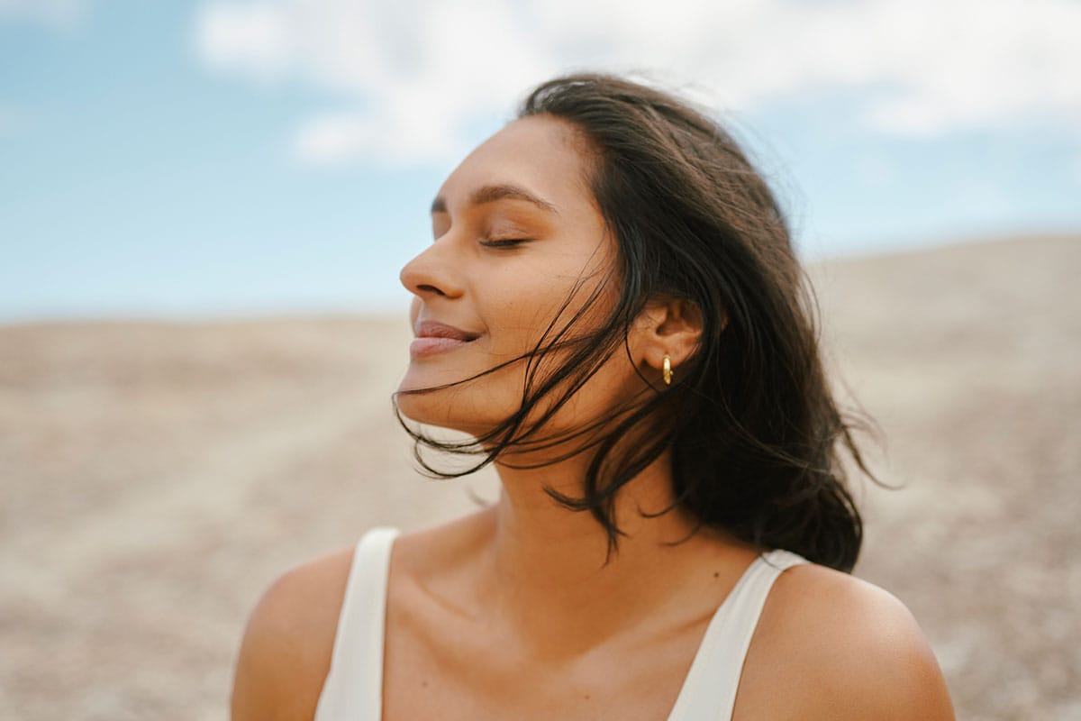 woman feeling good after taking her probiotic, called Korbiotic